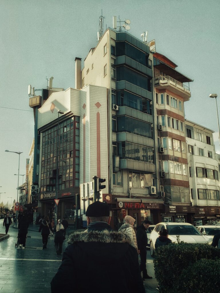 Street scene featuring modern architecture and pedestrians in daylight.